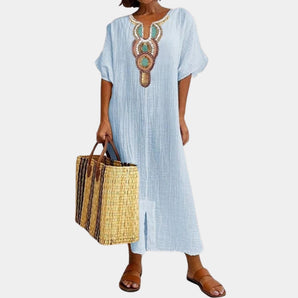 Light blue bohemian maxi dress featuring ethnic embroidery, with a focus on the shoulder, neck, and sleeve design. Suitable for plus size 3XL, highlighting a fashion-forward style.