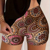 Bohemian Mandala High Waist Festival Beach Shorts featuring a vibrant summer design, worn by a person showcasing the shorts with emphasis on the waist and thigh area.