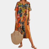 Colorful abstract print Bohemian midi dress in orange, featuring a loose fit with a focus on comfortable summer wear; designed with a classic neckline, short sleeves, and a flowing silhouette ideal for casual fashion.