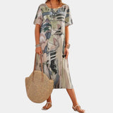 Bohemian midi dress featuring a colorful abstract print, shown in gray, with a loose fit design. The dress has short sleeves, a round neckline, and a length that falls around the knee. Suitable for summer wear.