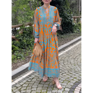 Bohemian Moroccan print maxi kaftan in orange and blue, featuring a flowing one-piece design with a relaxed fit, long sleeves, and a stylish round neckline, ideal as a beach cover-up.