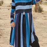 A woman wearing a Bohemian multi-color striped tunic dress with long sleeves in sky blue, size 7XL(58), smiling.
