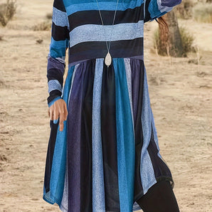 A woman wearing a Bohemian multi-color striped tunic dress with long sleeves in sky blue, size 7XL(58), smiling.