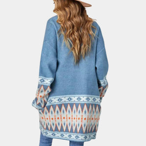 Bohemian oversized Aztec knit sweater for women in light blue, showcasing a winter fashion design with a loose fit and intricate patterns. The sweater is displayed on a mannequin, highlighting the shoulder and neck area.