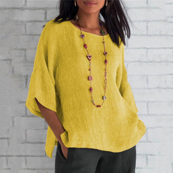 
A woman wearing a yellow oversized linen tunic, styled as a casual summer blouse. The tunic features a loose fit with wide sleeves and a relaxed collar, ideal for a comfortable and stylish look.