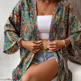 
A vibrant Bohemian Paisley Kimono worn as a colorful summer jacket and beach cover-up, featuring flowing sleeves and intricate textile patterns, paired with a stylish fedora hat.