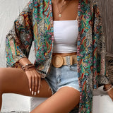 Colorful bohemian paisley kimono worn as a stylish summer jacket and beach cover-up, featuring vibrant patterns and flowing sleeves. The garment is shown draped over a casual outfit, highlighting its versatile fashion appeal.