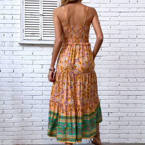 Bohemian Paisley Maxi Dress in yellow floral pattern with a strappy back design, featuring a flowing silhouette and sleeveless style ideal for daytime wear.