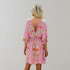 Bohemian pink floral V-neck dress with tribal print, featuring short sleeves and a cinched waist for a flattering silhouette.