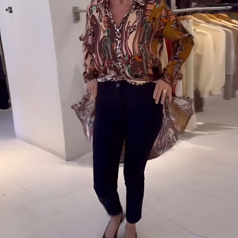 Bohemian silk blouse with designer printed pattern, featuring bell sleeves and a loose, flowing fit. The blouse is styled as a formal and fashionable top.