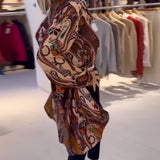 Bohemian silk blouse with designer printed patterns, featuring distinctive bell sleeves and a relaxed fit.