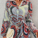 Bohemian tie-waist blouse featuring a colorful geometric mandala print, V-neck, long sleeves, and adjustable waist tie.