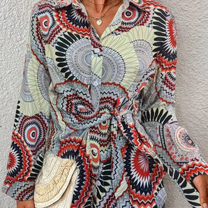 Bohemian tie-waist blouse featuring a colorful geometric mandala print, V-neck, long sleeves, and adjustable waist tie.