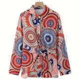 Bohemian tie-waist blouse with colorful geometric mandala print, features a V-neck and long sleeves, displayed on a clothes hanger.
