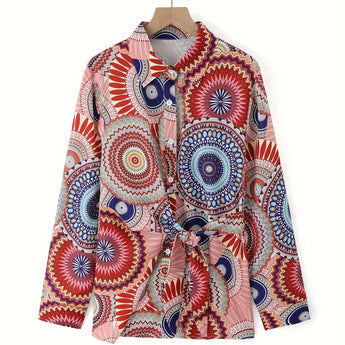 Bohemian tie-waist blouse with colorful geometric mandala print, features a V-neck and long sleeves, displayed on a clothes hanger.