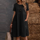 
Plus size black Bohemian tiered midi dress with a scoop neck and short sleeves, designed for a relaxed fit and suitable for daytime wear.