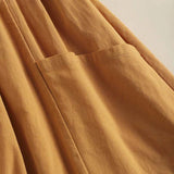 Bohemian tiered midi dress in brown with a scoop neck and short sleeves, designed for plus sizes. The dress features a layered design and a casual, flowy silhouette.