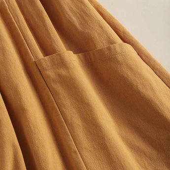 Bohemian tiered midi dress in brown with a scoop neck and short sleeves, designed for plus sizes. The dress features a layered design and a casual, flowy silhouette.