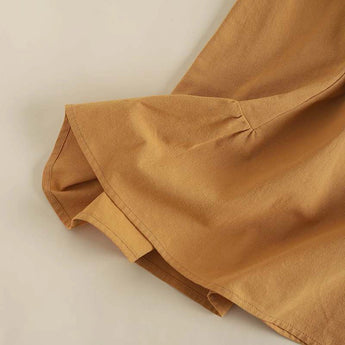 Bohemian tiered midi dress in a warm beige color, featuring a scoop neck and short sleeves, designed for plus sizes.