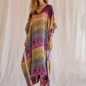 Bohemian V-Neck Tribal Print Kaftan Dress, luxury summer beachwear, featuring a flowy one-piece garment with intricate tribal patterns, V-neckline, and short sleeves, showcased on a model with long hair, wearing shoes.