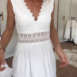 White lace summer dress featuring a bohemian style with a V-neck design, showcasing elegant sleeves and intricate embellishments.