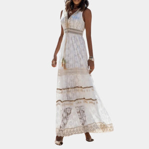 Bohemian white lace maxi dress with a sleeveless design and V-neckline, styled for a summer beach look.