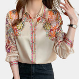 Bohemian women's floral print blouse in beige, featuring a V-neck design, long sleeves, and a relaxed fit, ideal for spring fashion.
