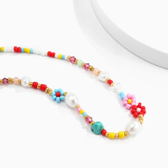 Multicolor pearl bead choker necklace featuring a boho design with floral accents, displayed as a trendy fashion accessory for women.