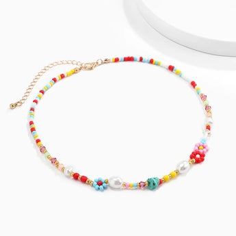 Multicolored pearl boho bead choker necklace featuring floral and trendy designs, displayed on a creative arts background.
