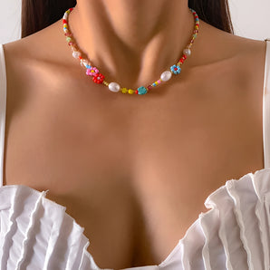 Colorful Boho bead choker necklace featuring multicolor pearls and floral design, displayed on a model wearing white outerwear and sunglasses.