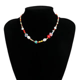 Multicolor pearl Boho bead choker necklace featuring floral and trendy designs, accessorized with gemstones and fashion elements, displayed on a neck model.