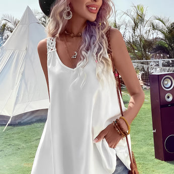 
A woman wearing a boho-chic crochet back sundress in white, size 2XL, accessorized with a wide-brimmed sun hat and sunglasses, standing outdoors under a clear sky. The dress features a sleeveless design, fitted at the waist and flowing to mid-thigh.