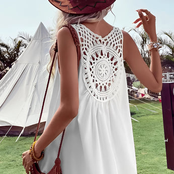 Boho-Chic Crochet Back Sundress worn by a woman in a sun hat, standing in a grassy field under a clear sky, showcasing summer festival fashion style.