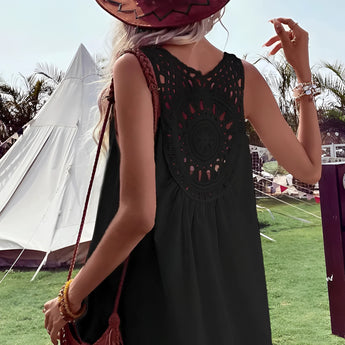 Boho-Chic Crochet Back Sundress featuring a lightweight, airy design, perfect for summer festivals. The image shows a woman wearing the dress paired with a sun hat, standing outdoors on grass with a clear sky backdrop, capturing a relaxed, bohemian vibe.