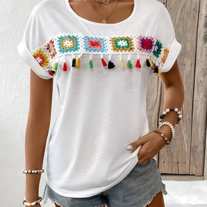 Boho Chic Embroidered Tassel Top featuring intricate embroidery, tassels, and a relaxed fit, designed as a women's festival blouse with long sleeves and a stylish neckline in a mix of white and black.