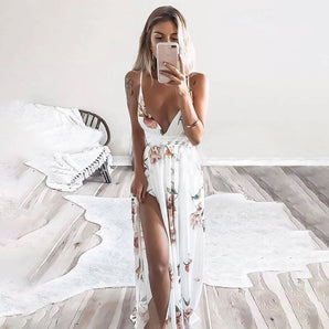 
A plus-size model wearing a boho chic floral print maxi dress with a plunging V-neckline. The dress features long sleeves and a flattering waistline, highlighting a comfortable yet stylish fit. The model poses in a well-lit setting, showcasing the dress's intricate design and flowy skirt.