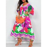 Boho chic long sleeve maxi dress with a vibrant abstract print in shades of pink and magenta, featuring a defined waist and flowing design suitable for spring fashion.