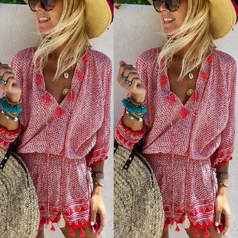 Boho Chic Patterned Pink Fringe Dress for women, styled with a summer beach theme. The dress features fringe details and a bohemian pattern, complemented by a sun hat and sunglasses for a complete summer look.