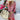 Boho chic women's summer beachwear featuring a pink fringe dress with a patterned design, accessorized with a sun hat and surrounded by vibrant flowers.
