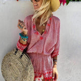 Boho Chic Patterned Pink Fringe Dress worn by a woman outdoors, featuring a bohemian design with fringes, in a red color. The dress has short sleeves and a relaxed fit suitable for summer beachwear. The woman appears happy and is accessorized with sunglasses.