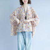 Boho chic V-neck blouse with a leaf pattern, featuring wide sleeves and a relaxed fit, designed for women.