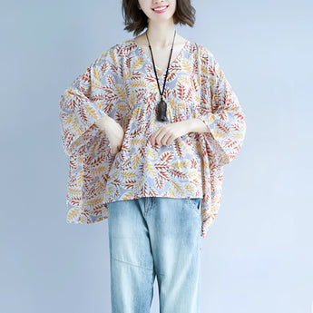 Boho chic V-neck blouse with a leaf pattern, featuring wide sleeves and a relaxed fit, designed for women.