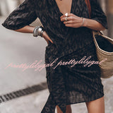 Boho-Chic V-Neck Mini Dress in monochrome, featuring a white and black pattern, short sleeves, and a defined waist, suitable for summer or as a beach cover-up.