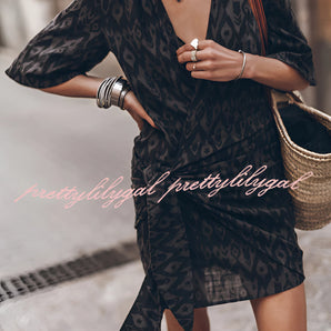 Boho-Chic V-Neck Mini Dress in monochrome, featuring a white and black pattern, short sleeves, and a defined waist, suitable for summer or as a beach cover-up.