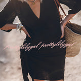 Boho-Chic V-Neck Mini Dress in a summer style, featuring a white fabric with black accents, short sleeves, and a flattering waistline, worn by a model with shoulder-length hair, highlighting the dress's suitability as both a casual summer outfit and a beach cover-up.