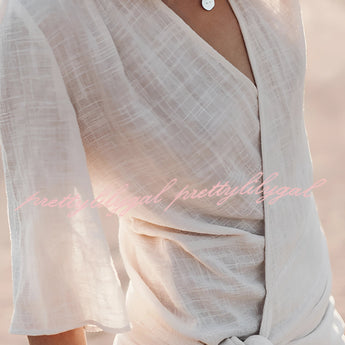 Boho-Chic V-Neck Mini Dress in white, featuring a lightweight textile with short sleeves and a flattering waistline, perfect for summer outings or as a beach cover-up.
