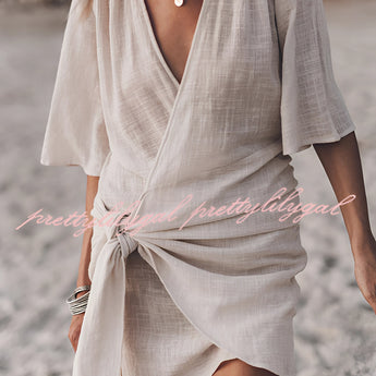 Boho-Chic V-Neck Mini Dress worn by a woman with sunglasses, featuring a loose-fitting design with short sleeves, cinched waist, and flowing fabric perfect for summer or as a beach cover-up.