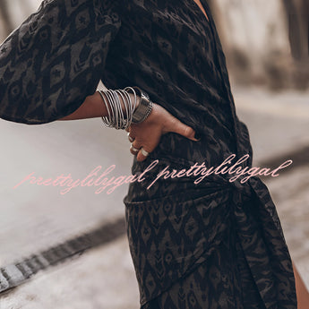 Boho-chic V-neck mini dress with a summer vibe, featuring a black and white tartan pattern, short sleeves, and a flattering waistline, suitable as a beach cover-up.