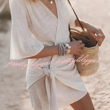 Boho-Chic V-neck mini dress featuring a stylish summer design, suitable as a beach cover-up, with short sleeves and a comfortable, flowy fabric.