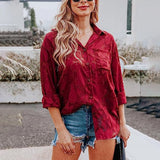 Red wine velvet blouse paired with distressed denim shorts set, featuring long sleeves and styled on a mannequin.